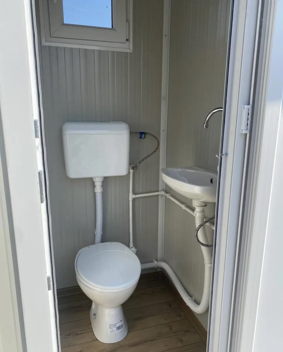 Inside a VIP flushing cabin with sink